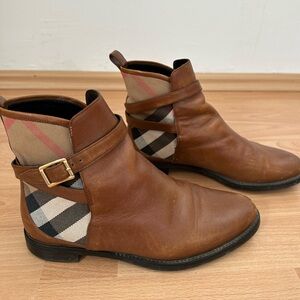 Burberry leather ankle boots with belt detail.